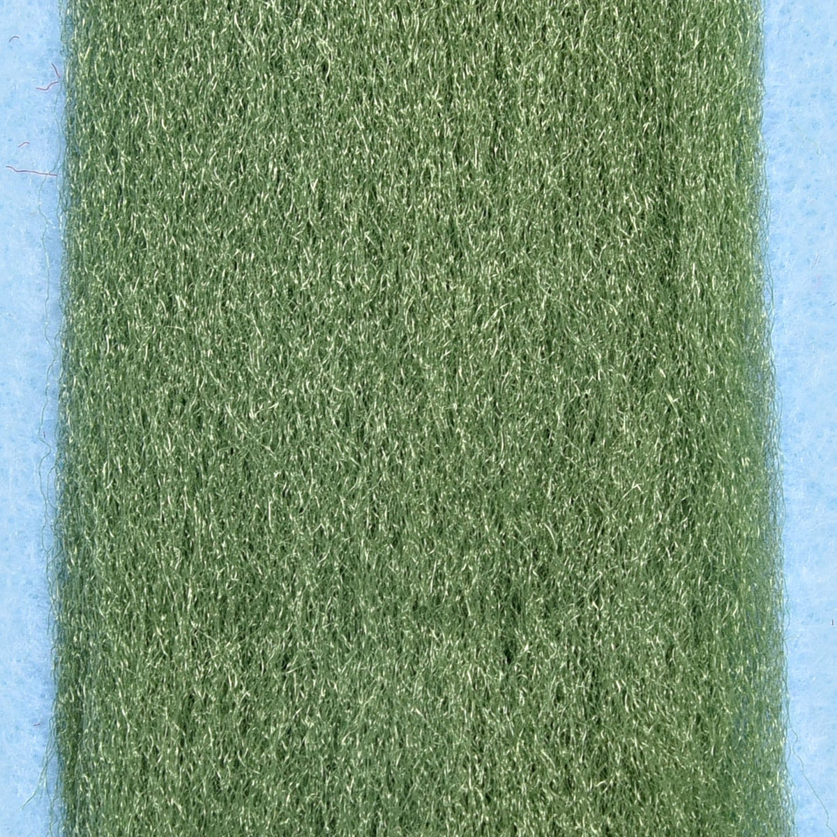 Olive green Enrico Puglisi silky fibers with fine reflective strands on blue backing, fly tying material
