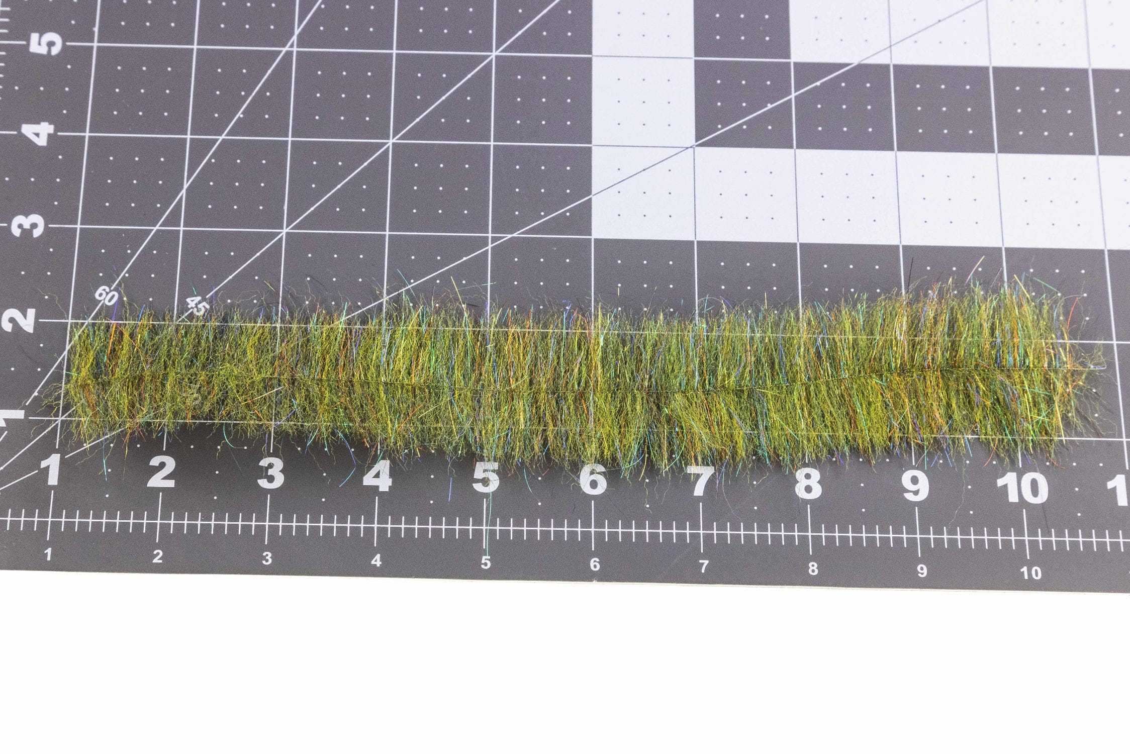Enrico Puglisi wide UV minnow head brush: olive green synthetic fibers with iridescent tinsel strip for fly tying