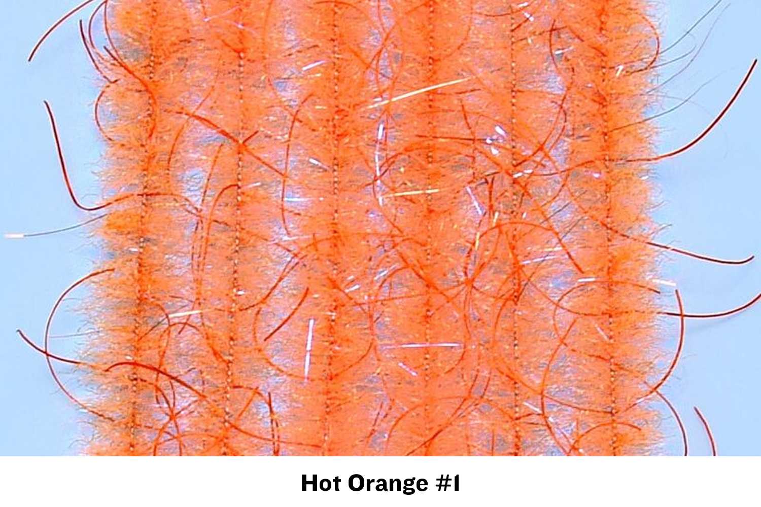 Hot orange Woolly Critter Brush with dense fuzzy synthetic fibers, long guard hairs and flash strands for fly tying