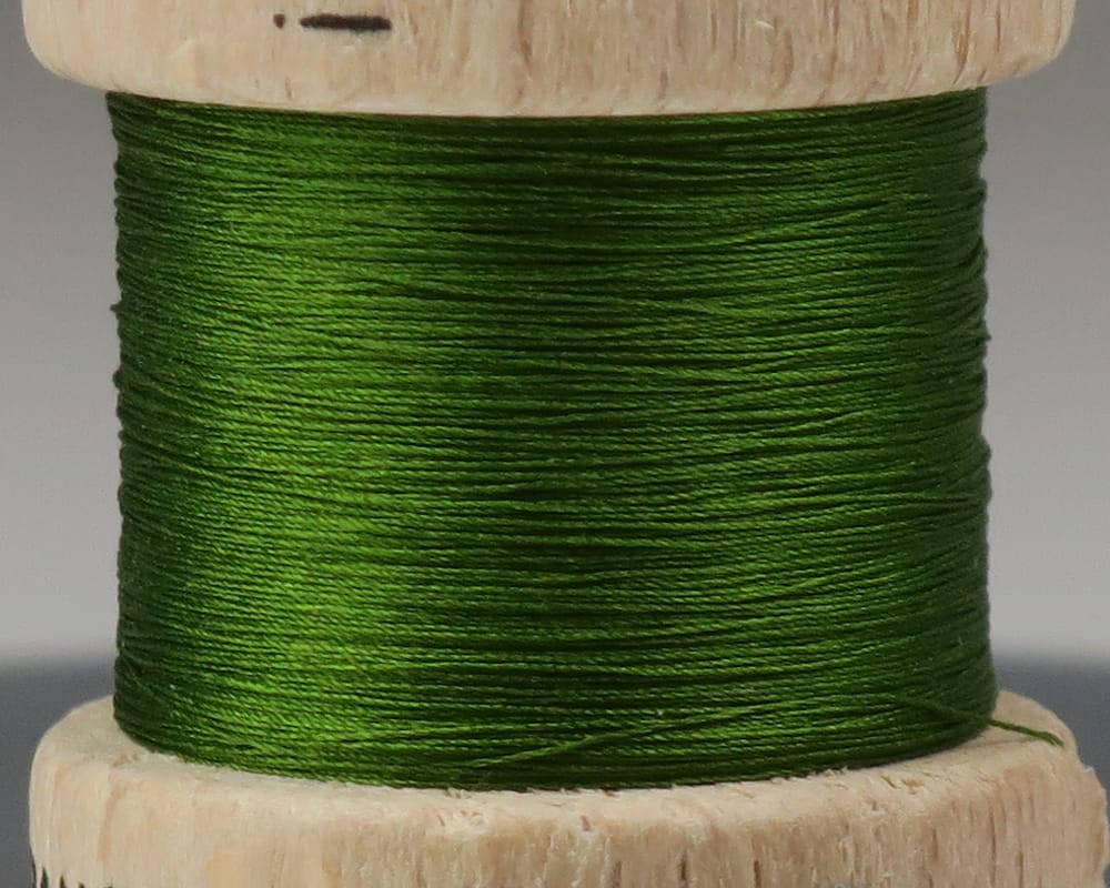 Emerald green pure silk thread wound on wooden spool, smooth glossy fly tying thread for precision flies