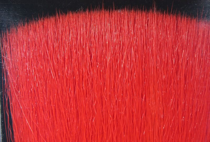 Fish-Skull red faux bucktail: dense long synthetic fibers with subtle silver flash, ideal for fly tying