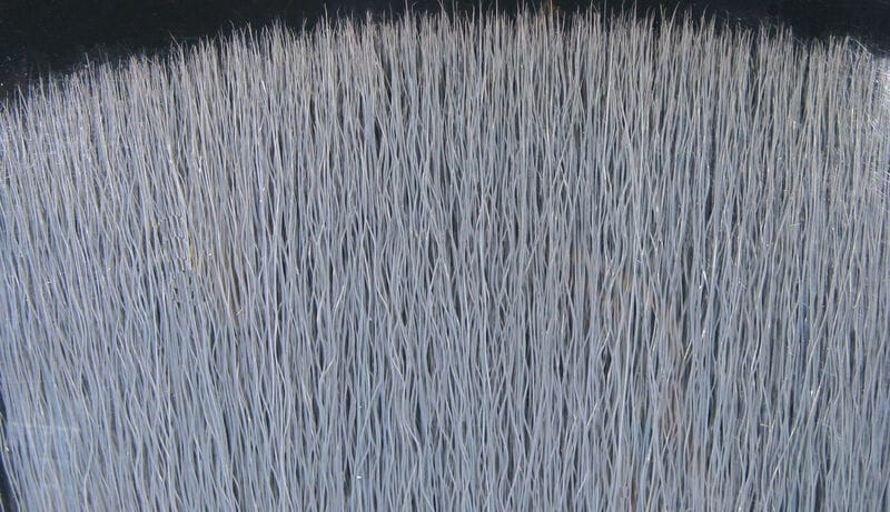 Silver-gray Fish-Skull faux bucktail synthetic fibers with subtle metallic flash, dense wavy strands for fly tying