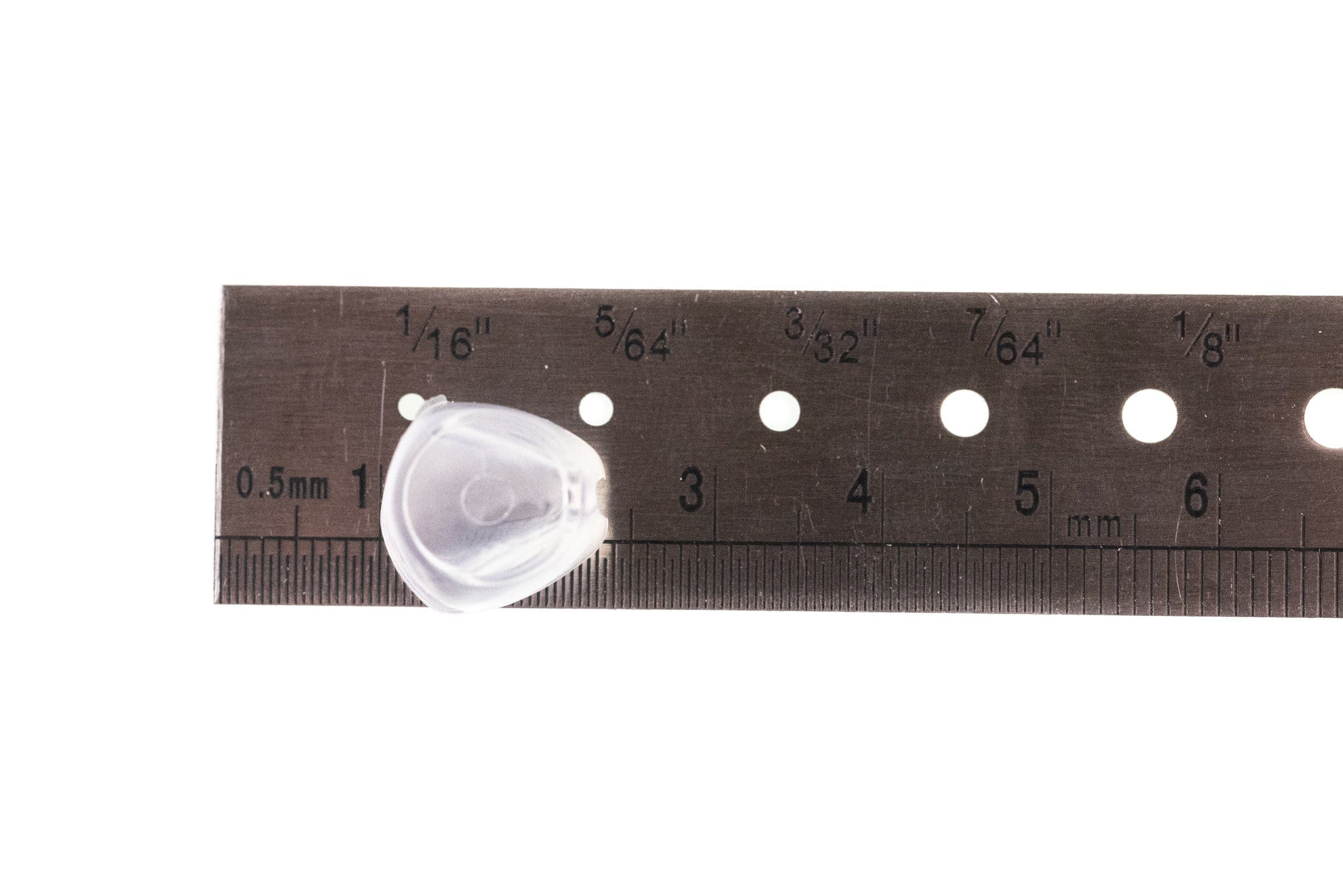 Translucent clear plastic Fish-Skull fish mask on metal ruler with inch/mm marks, small fly tying head component