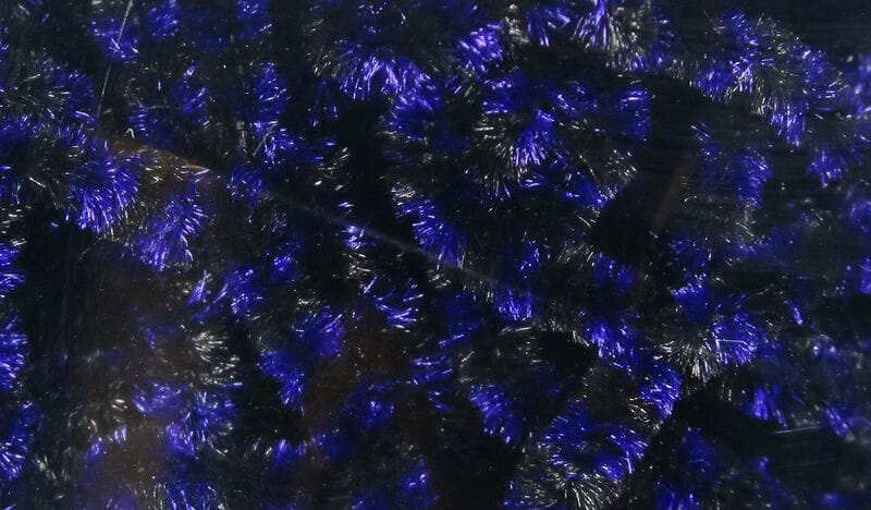 Deep blue and black metallic stonefly chenille with iridescent fuzzy tinsel fibers for fly tying