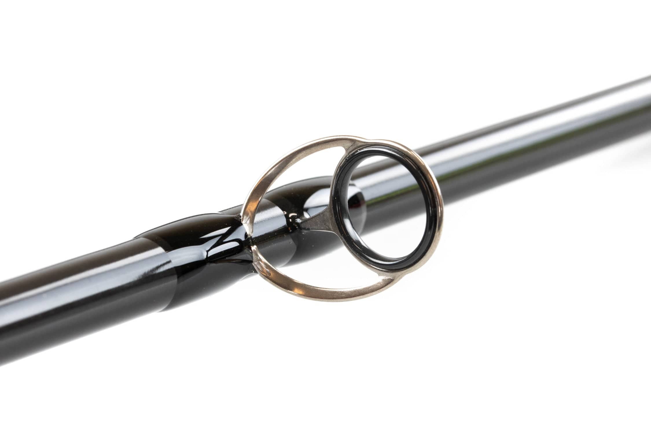 G. Loomis NRX+ Swim Fly fly rod close-up showing glossy black carbon blank and silver guide ring with ceramic insert