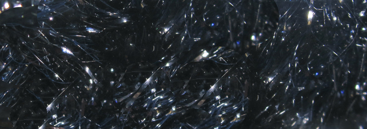 Dark iridescent black-blue chenille with reflective metallic flash fibers, fuzzy textured fly tying material