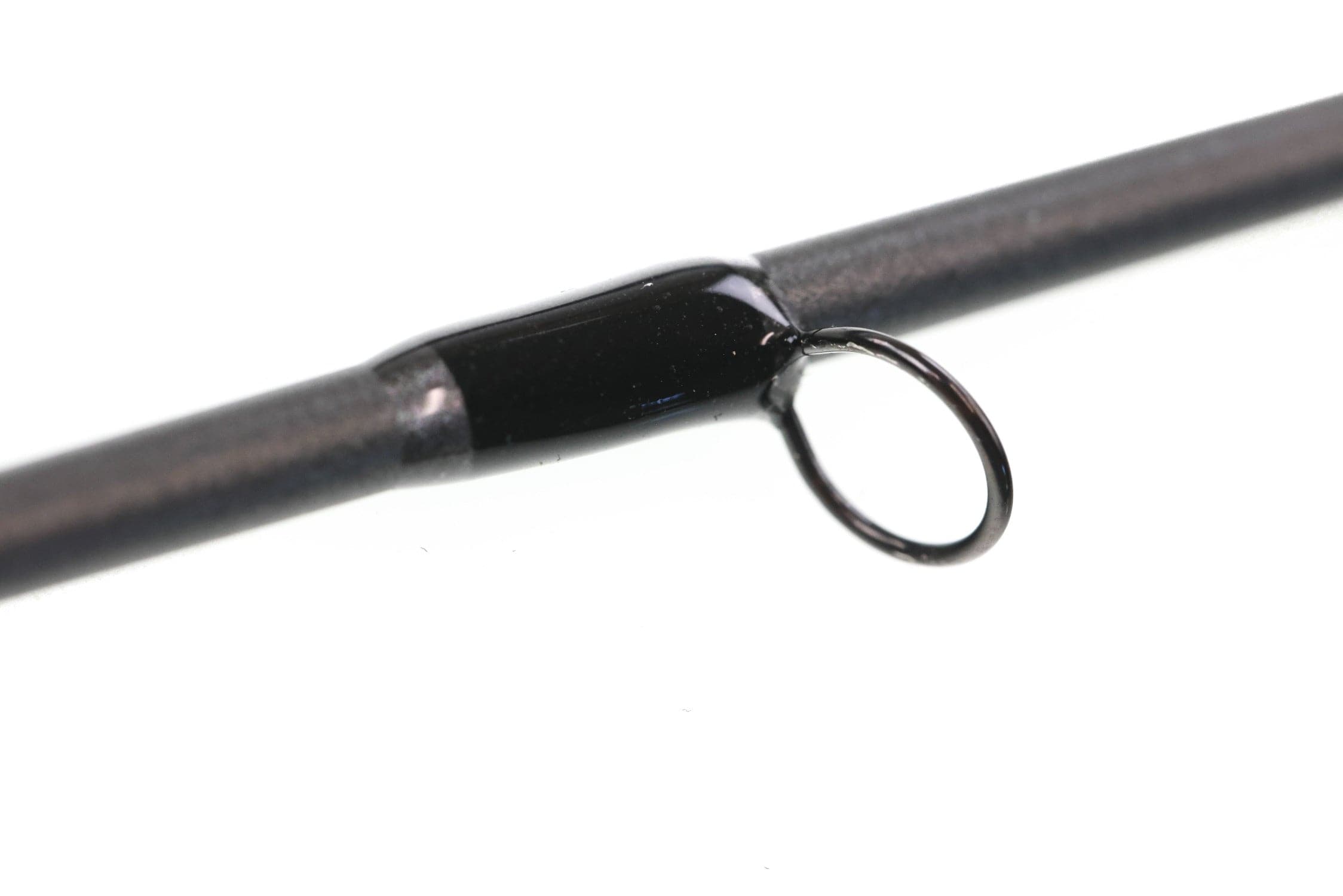 Greys Kite fly rod close-up: dark graphite blank with glossy black guide wrap and circular black guide ring