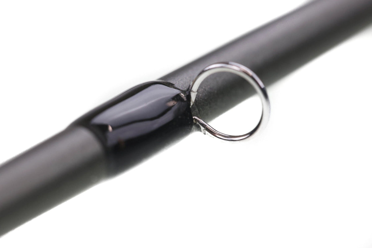 Greys Lance fly rod close-up with matte black blank, glossy black guide wrap and silver metal guide ring