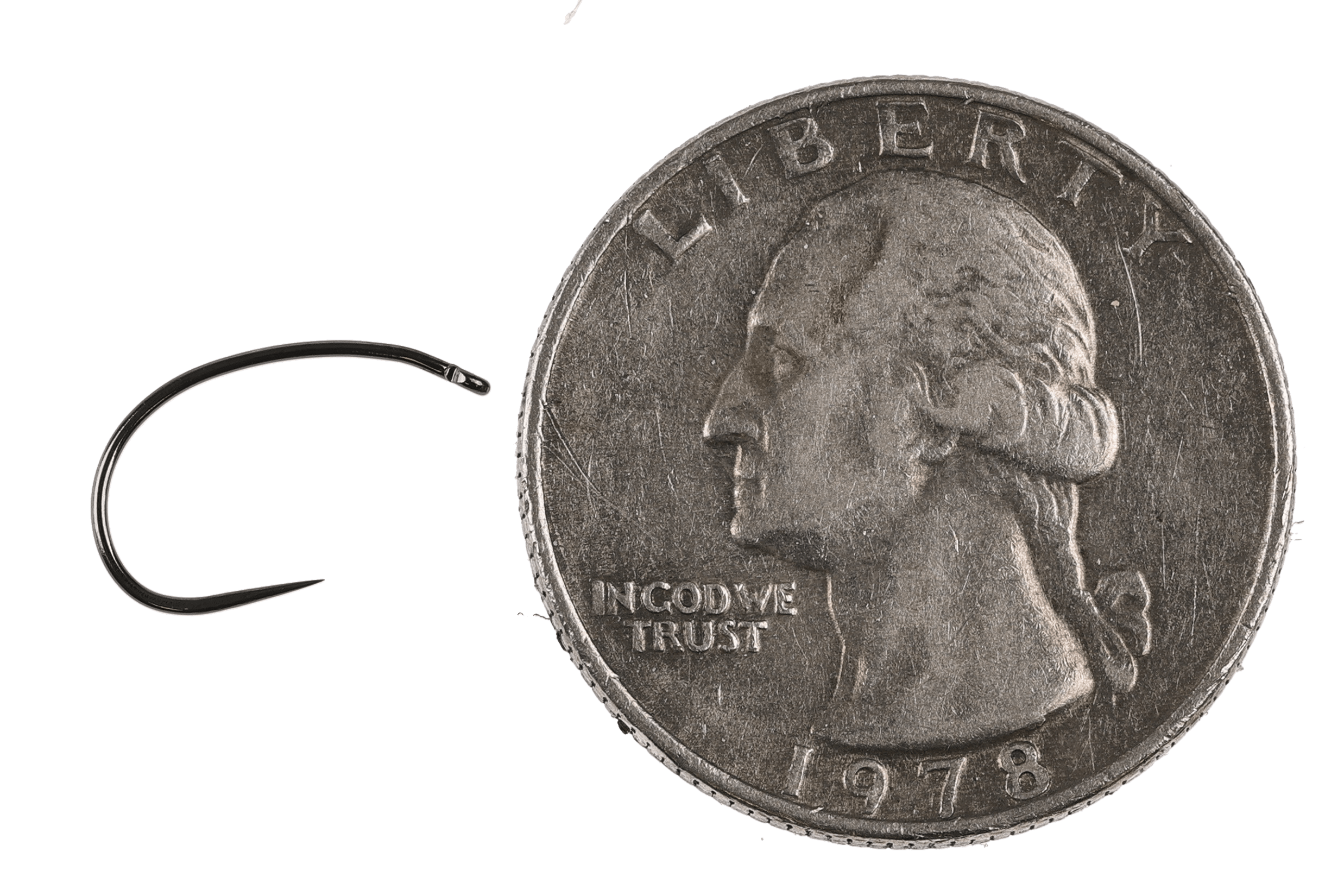 Black nickel Hanak Klinkhammer fly tying hook with curved shank, upturned eye beside US quarter for scale