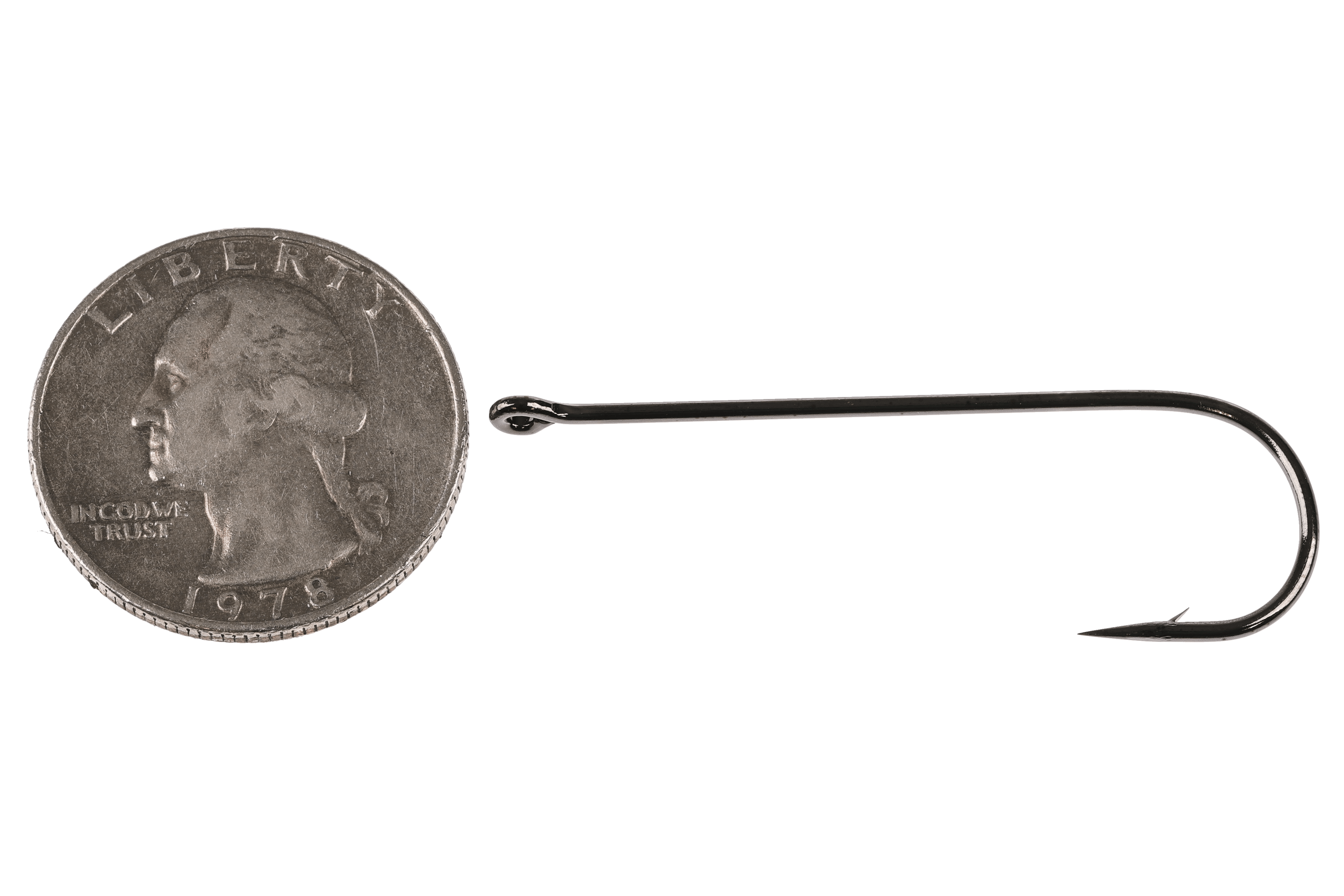 Hanak black nickel long-shank streamer hook with straight eye and sharp barb beside US quarter for scale, fly tying