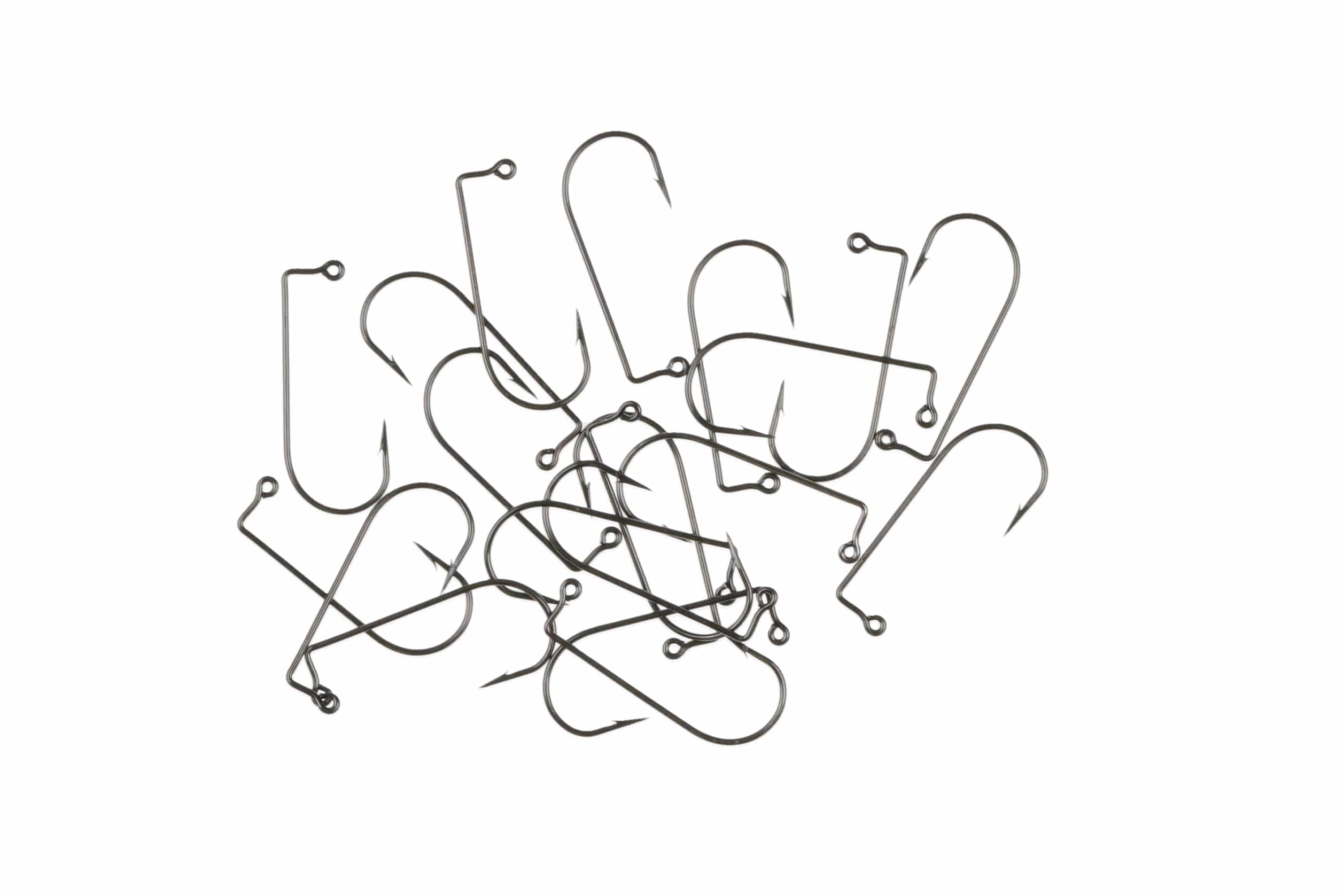 Scattered dark gunmetal 90-degree Aberdeen jig hooks with looped eyes, thin wire shanks and barbed points for fly tying