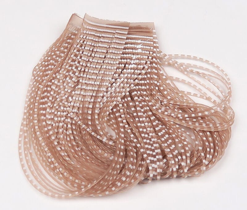 Tan translucent barred synthetic crusher legs with white square bars, flexible strips for fly tying
