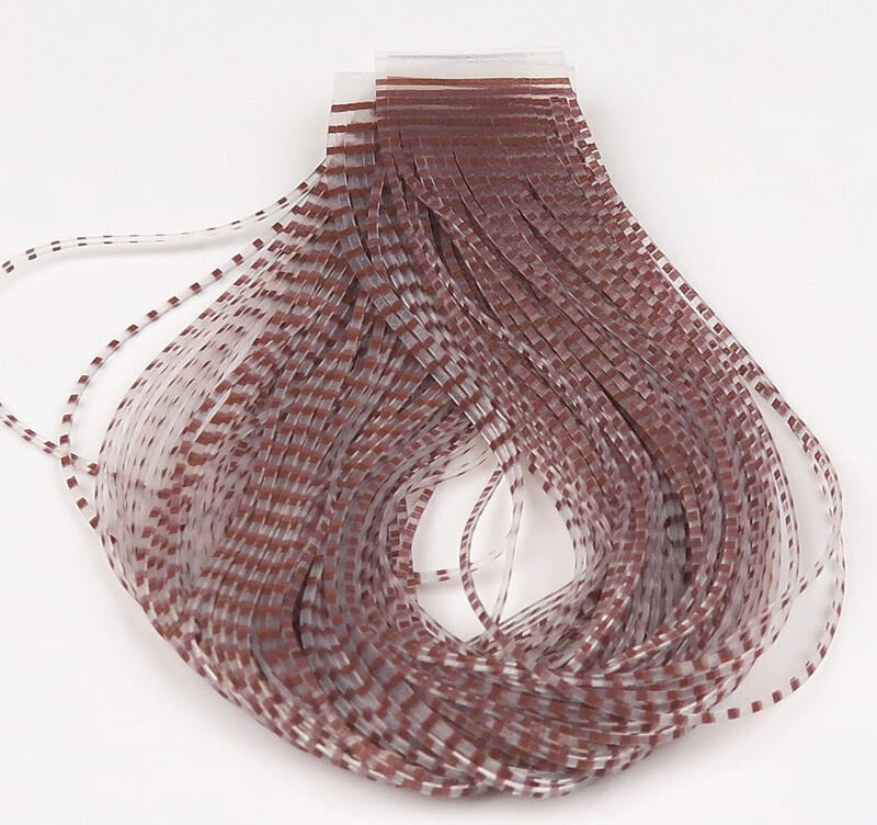 Hareline Chicone's barred crusher legs: translucent brown and white striped synthetic fly tying legs, thin flexible strips