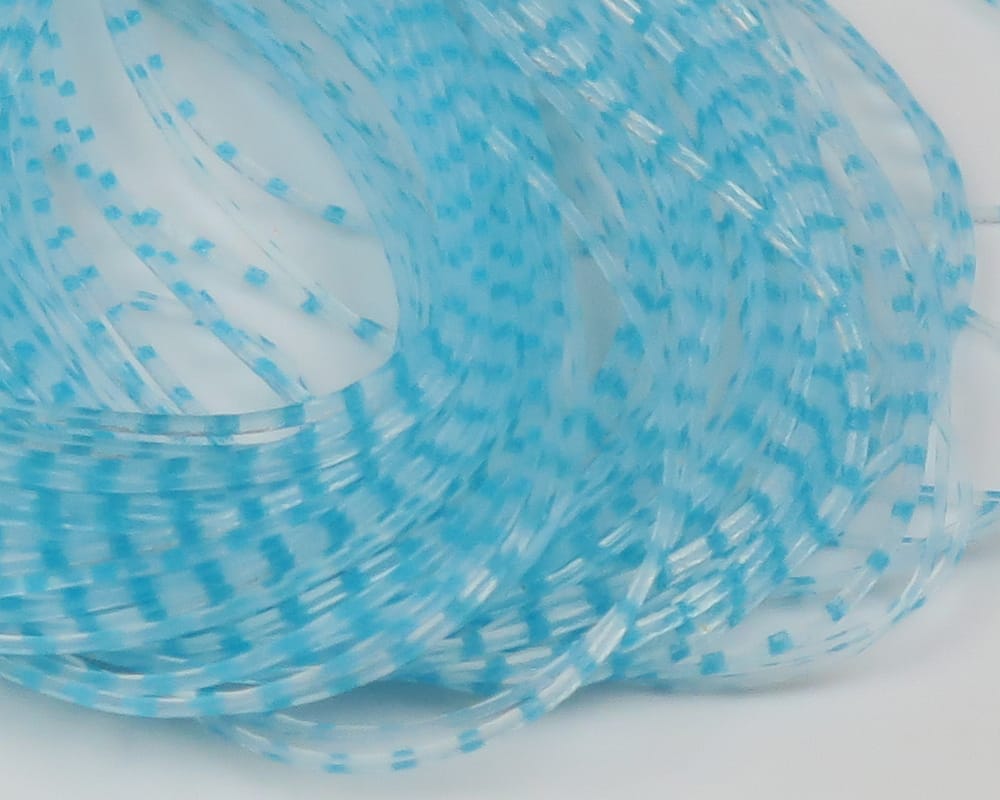 Light blue translucent barred plastic strands with reflective fibers — Chicone's Crusher Legs for fly tying