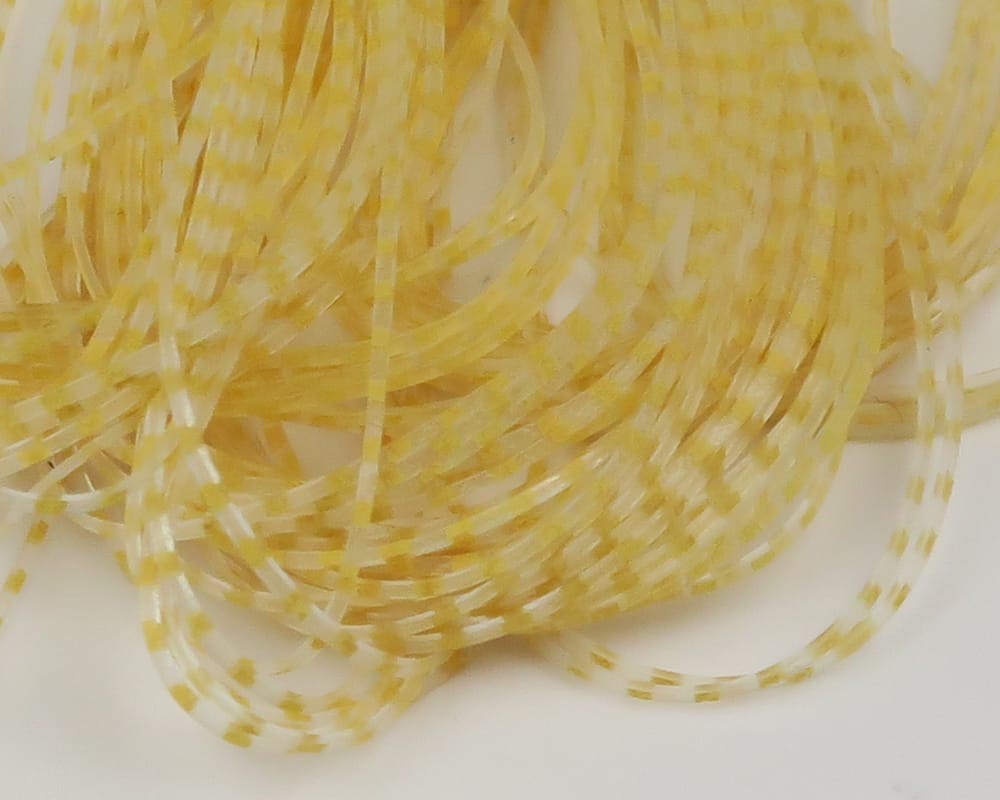 Pale yellow translucent barred crusher legs for fly tying, thin coiled rubber strands with white square bar pattern