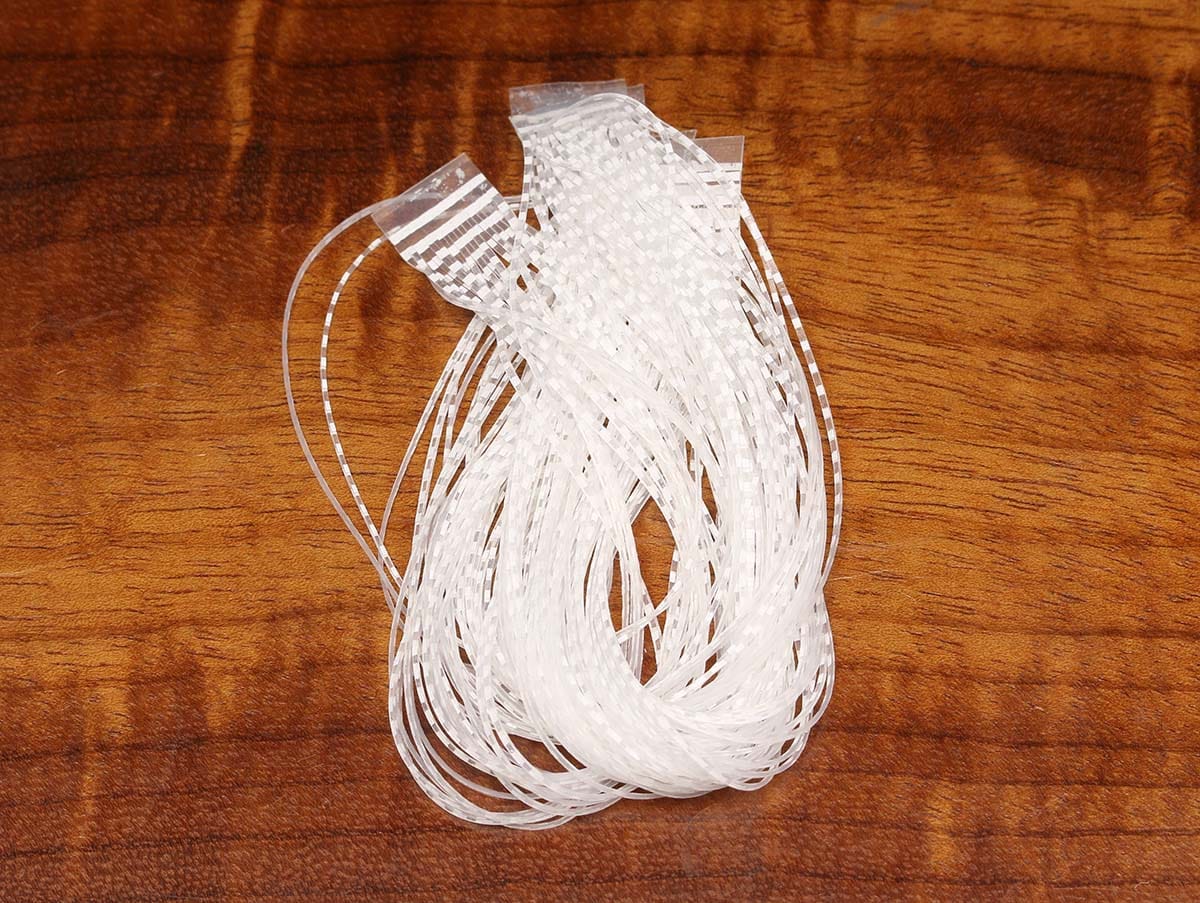 White translucent barred synthetic crusher legs bundle for fly tying, thin flexible plastic strands on wood background