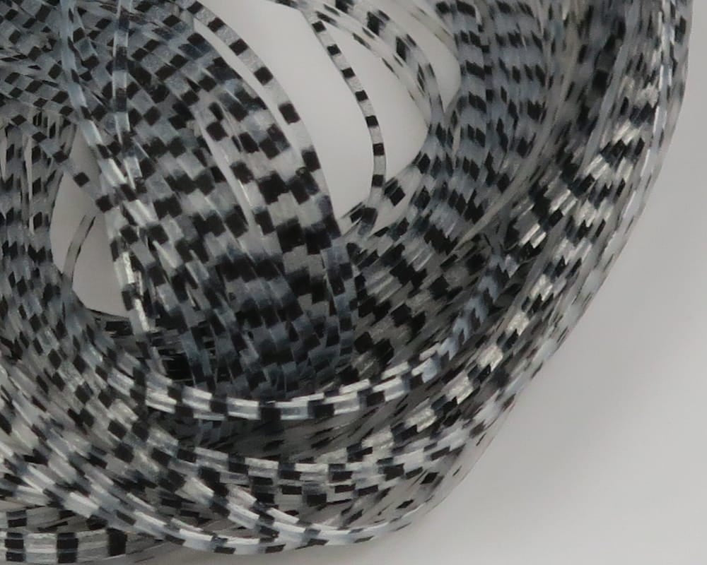 Coiled Hareline Chicone's Barred Crusher Legs, black and white barred synthetic fly tying material with glossy plastic sheen