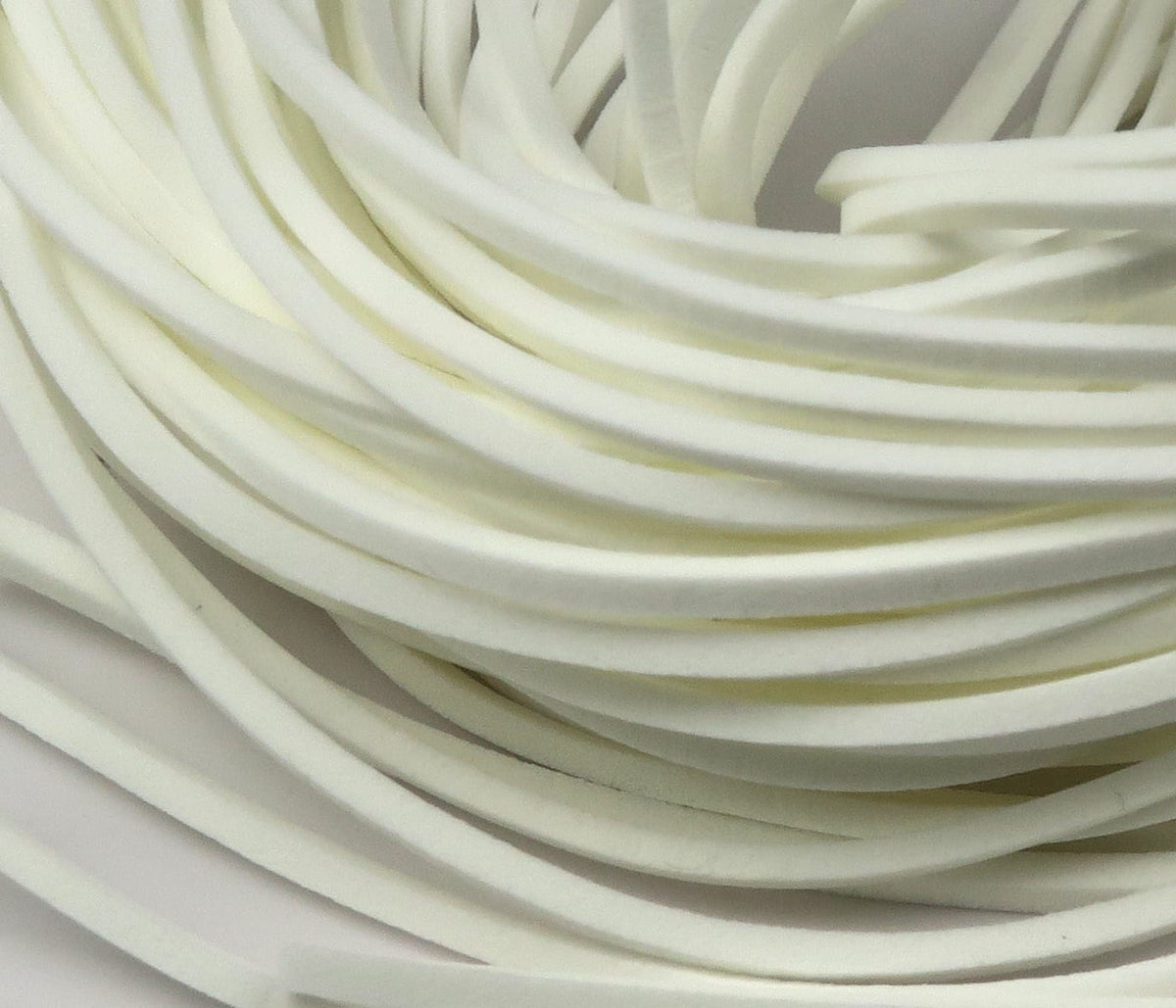 Cream-white fettuccine foam strips coiled, thin flat closed-cell foam for fly tying