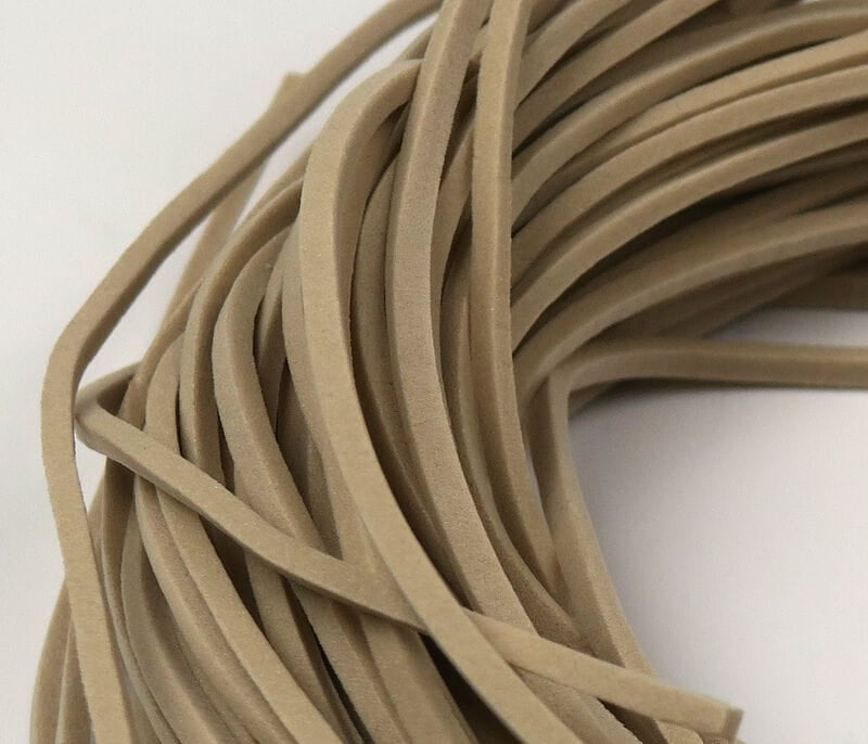Tan fettuccine foam strips, narrow flat foam strands with soft matte texture for fly tying and streamer bodies