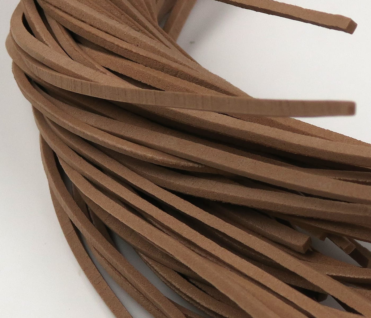 Brown fettuccine foam strips with suede texture, coiled bundle for fly tying and lure skirts