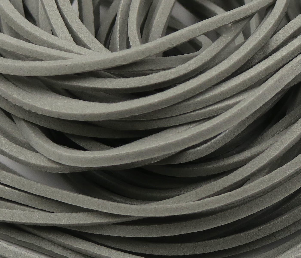 Close-up grey fettuccine foam strips, soft matte foam strands bundled for fly tying