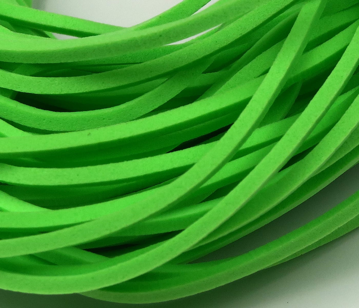 Neon green fettuccine foam strips, thin flat closed-cell foam strands for fly tying, bright matte texture