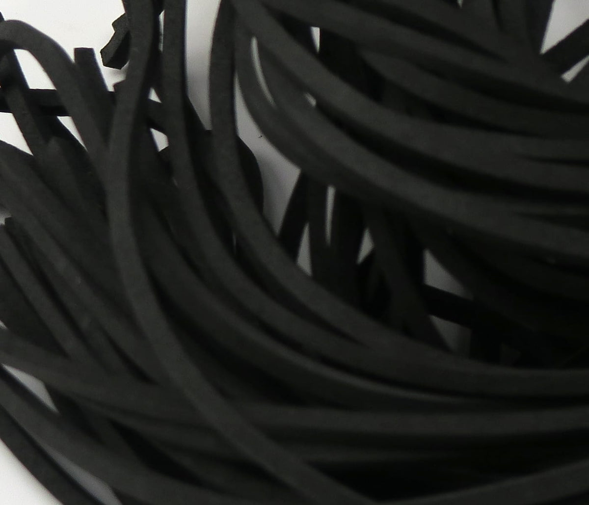 Black fettuccine foam strips for fly tying, thin matte foam strands with flat rubbery texture