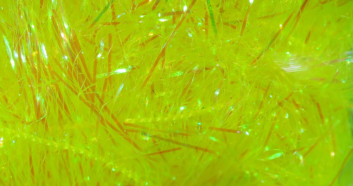 Chartreuse iridescent synthetic fibers with thin orange strips, Chocklett's Filler Flash for fly tying