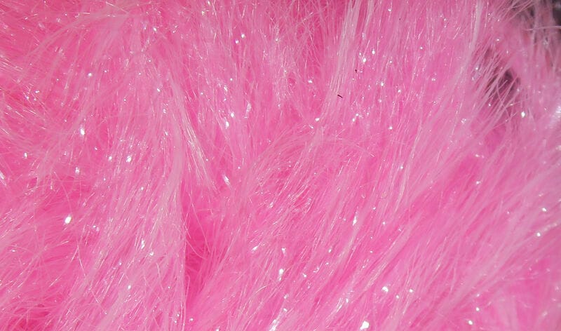 Bright pink Chocklett's Finesse body chenille with fine fluffy fibers and iridescent tinsel sparkle for fly tying