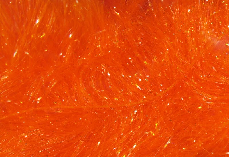 Bright orange Chocklett's Finesse body chenille with fine shiny synthetic fibers and iridescent tinsel for fly tying