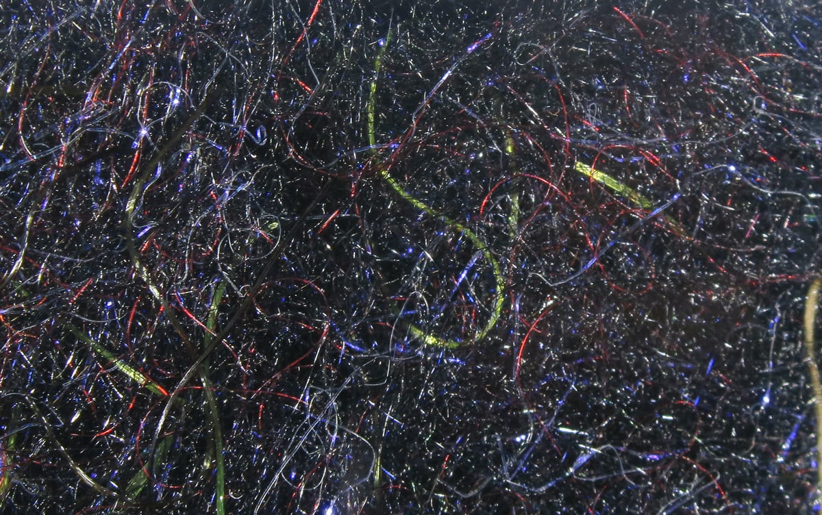 Black Cohen's Carp Dub fly tying dubbing with fine iridescent black fibers and red, blue, green flash strands