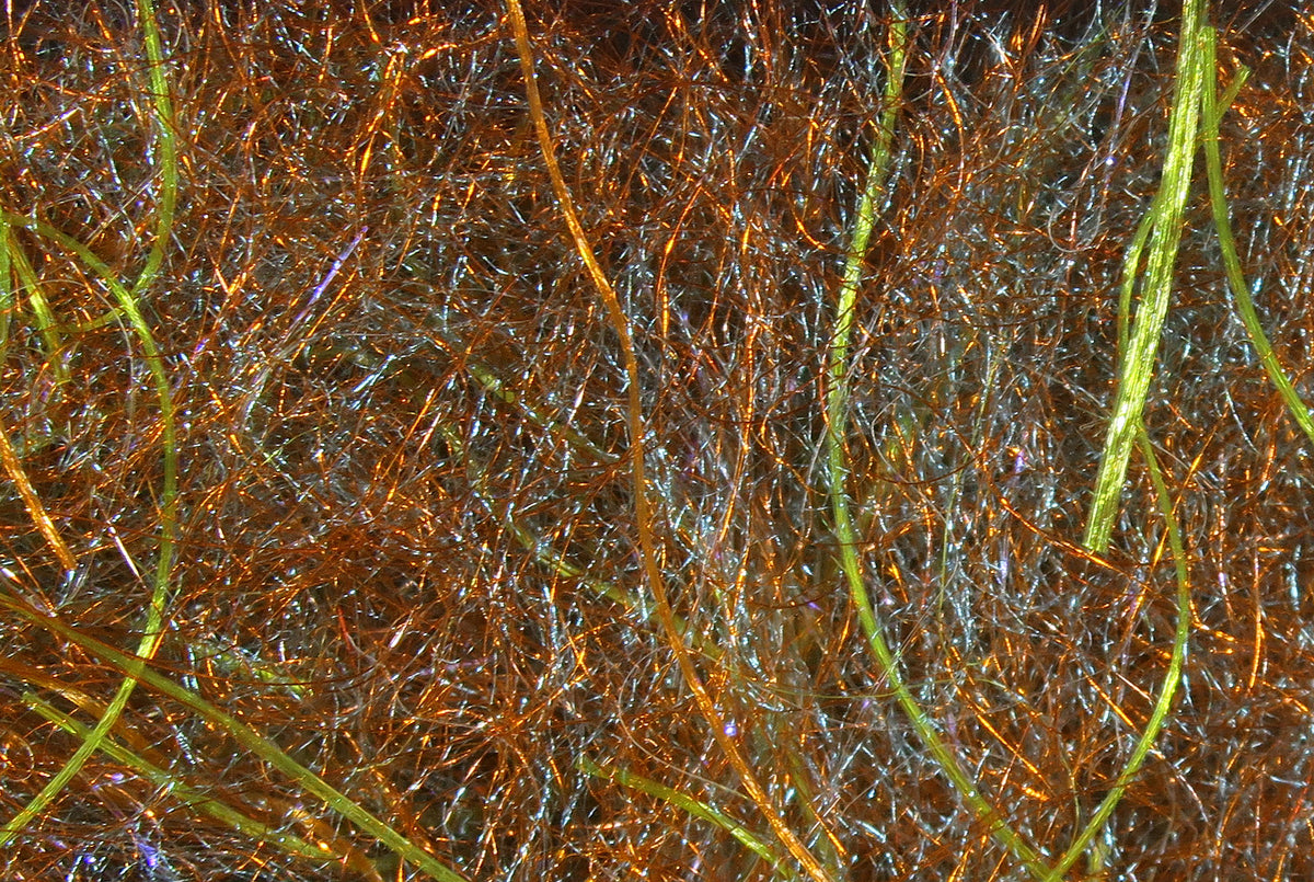 Copper-brown and olive iridescent synthetic dubbing fibers with fine flash strands for fly tying dub