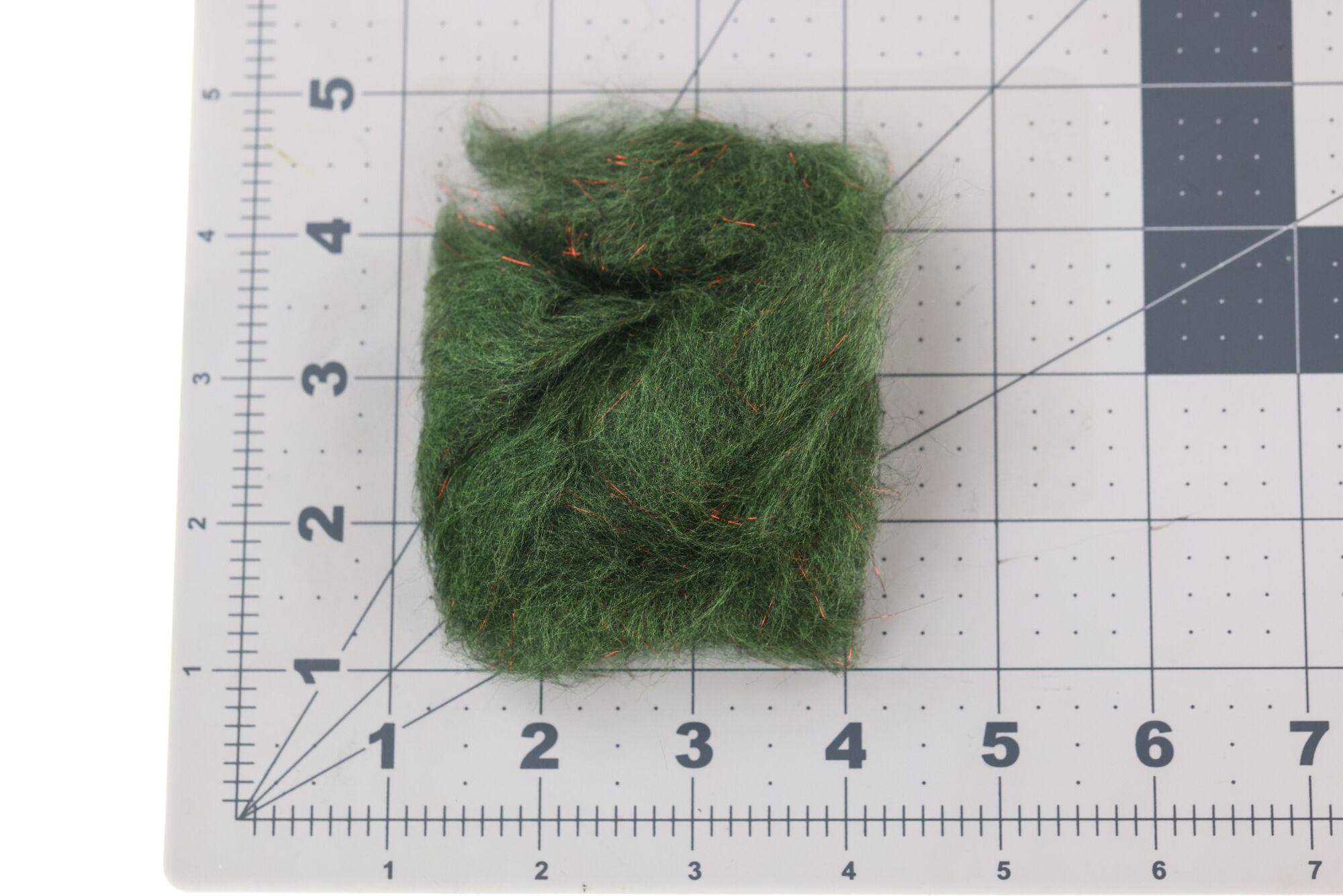 Olive green Jr. Bruiser dubbing bundle with copper flash fibers, fuzzy synthetic fly tying dubbing on grid mat