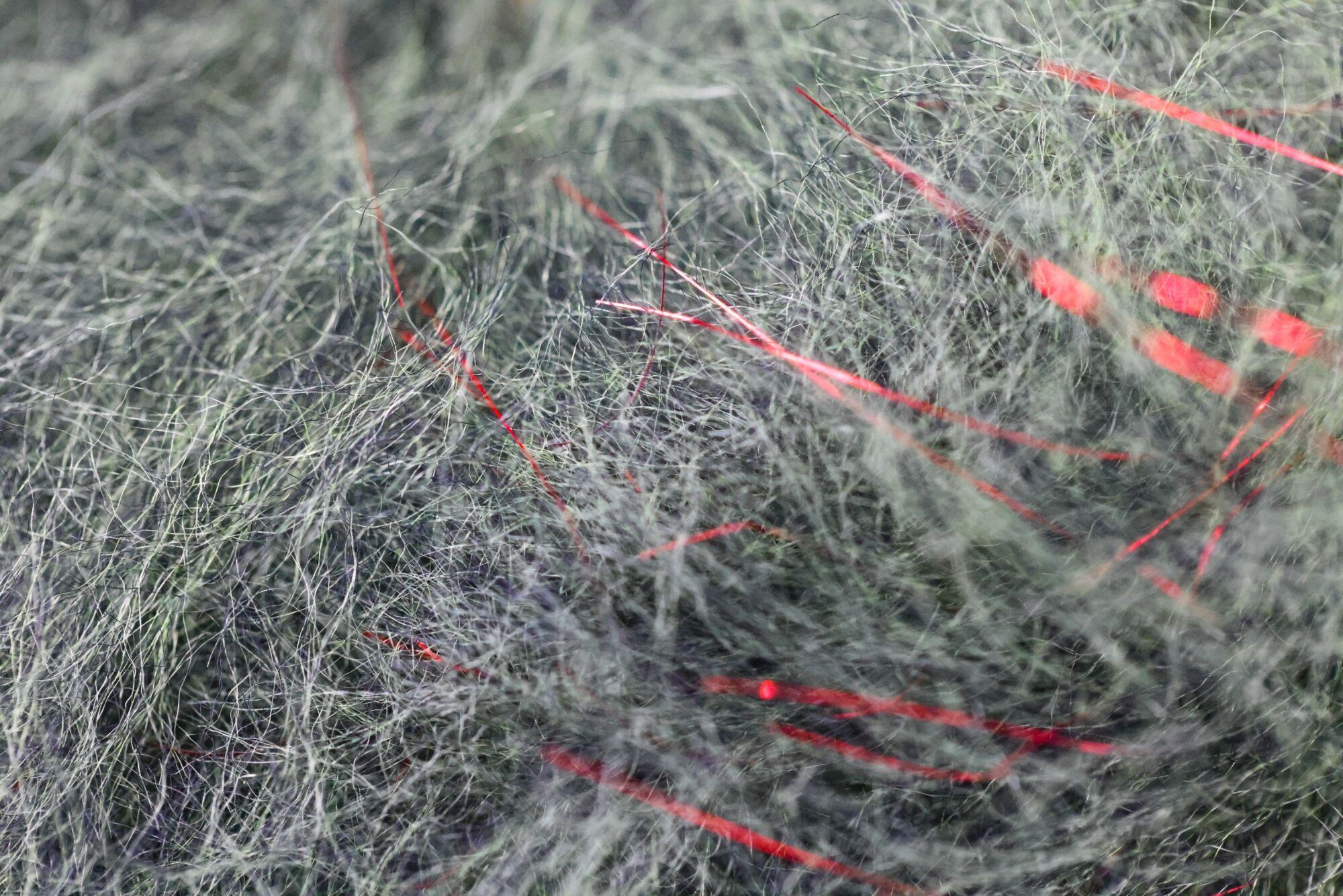 Olive-gray synthetic fly tying dubbing with wispy fur fibers and bright red metallic flash strands (Jr. Bruiser Blend)