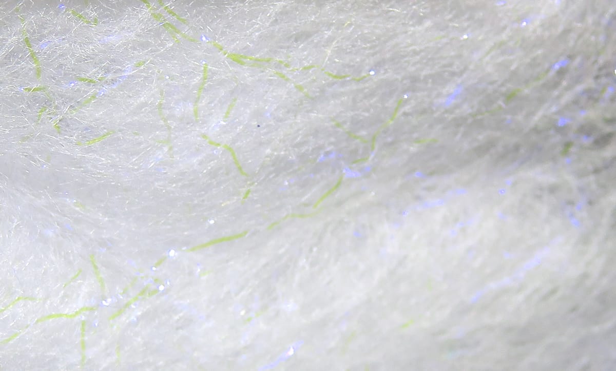 White synthetic Jr. Bruiser Blend dubbing with lime green fibers and blue iridescent flash, fluffy fly tying material