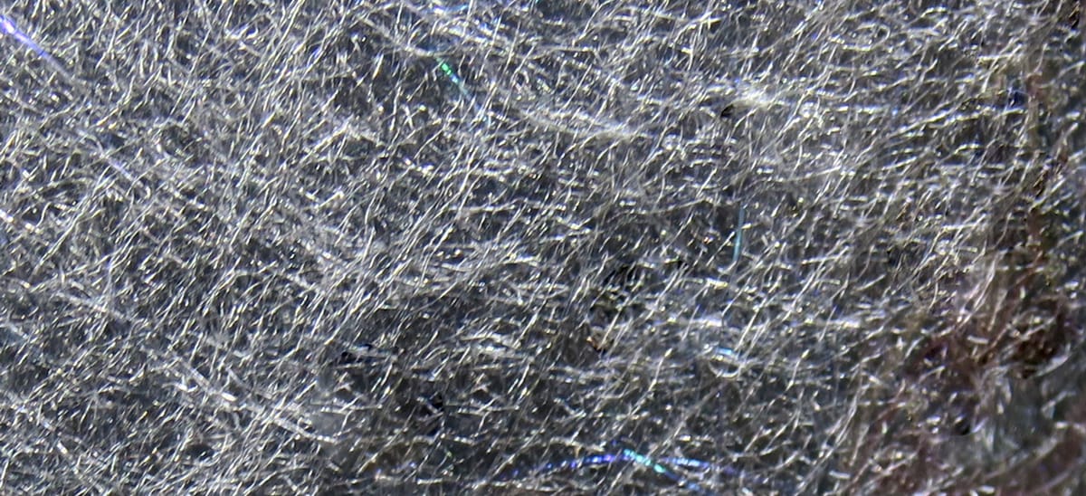 Silver-gray Hareline Jr. Bruiser Blend fly tying dubbing with fine synthetic fibers and iridescent flash