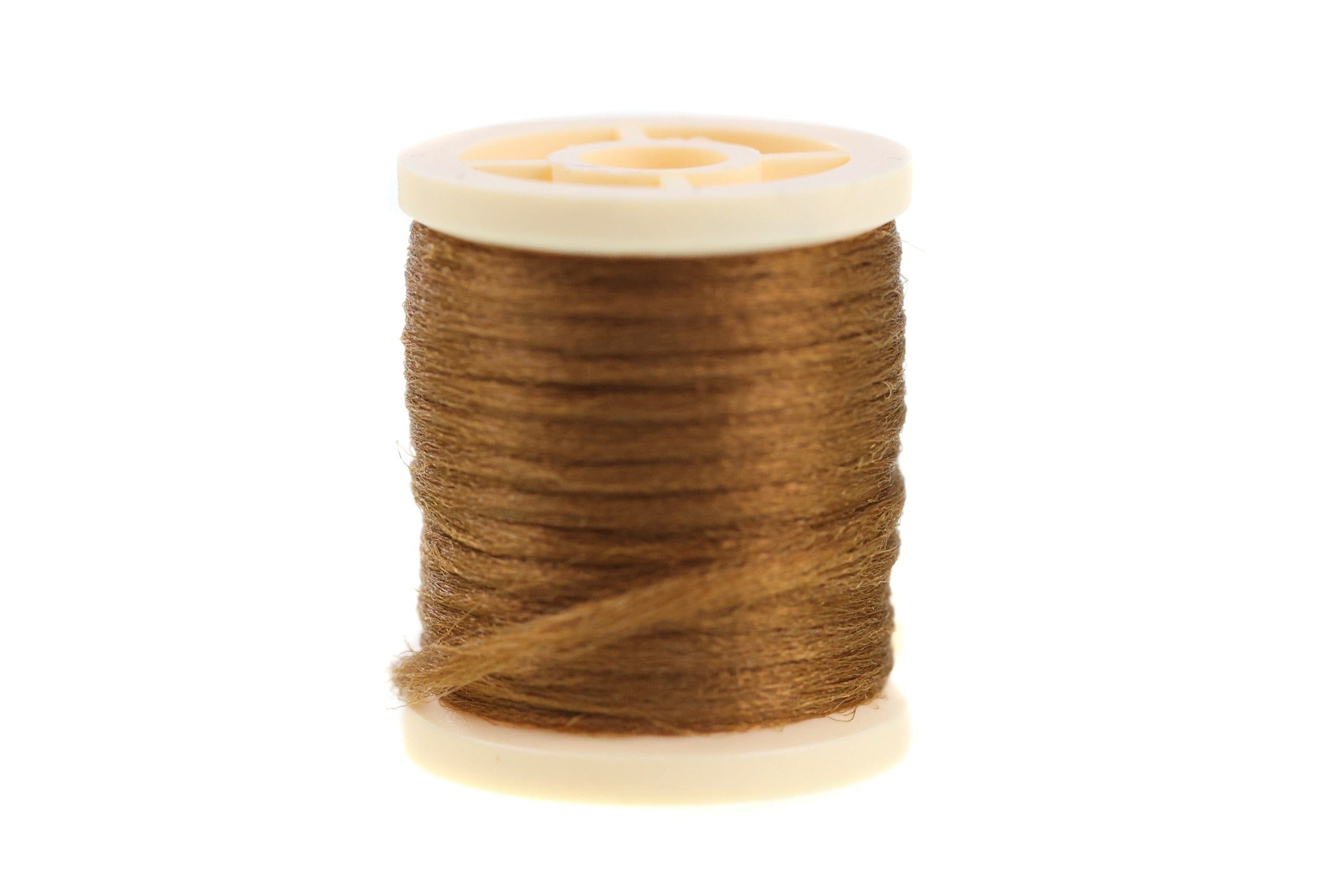 Spool of Hareline Antron yarn in copper-brown, slightly fuzzy synthetic fiber wound on a cream plastic bobbin for fly tying