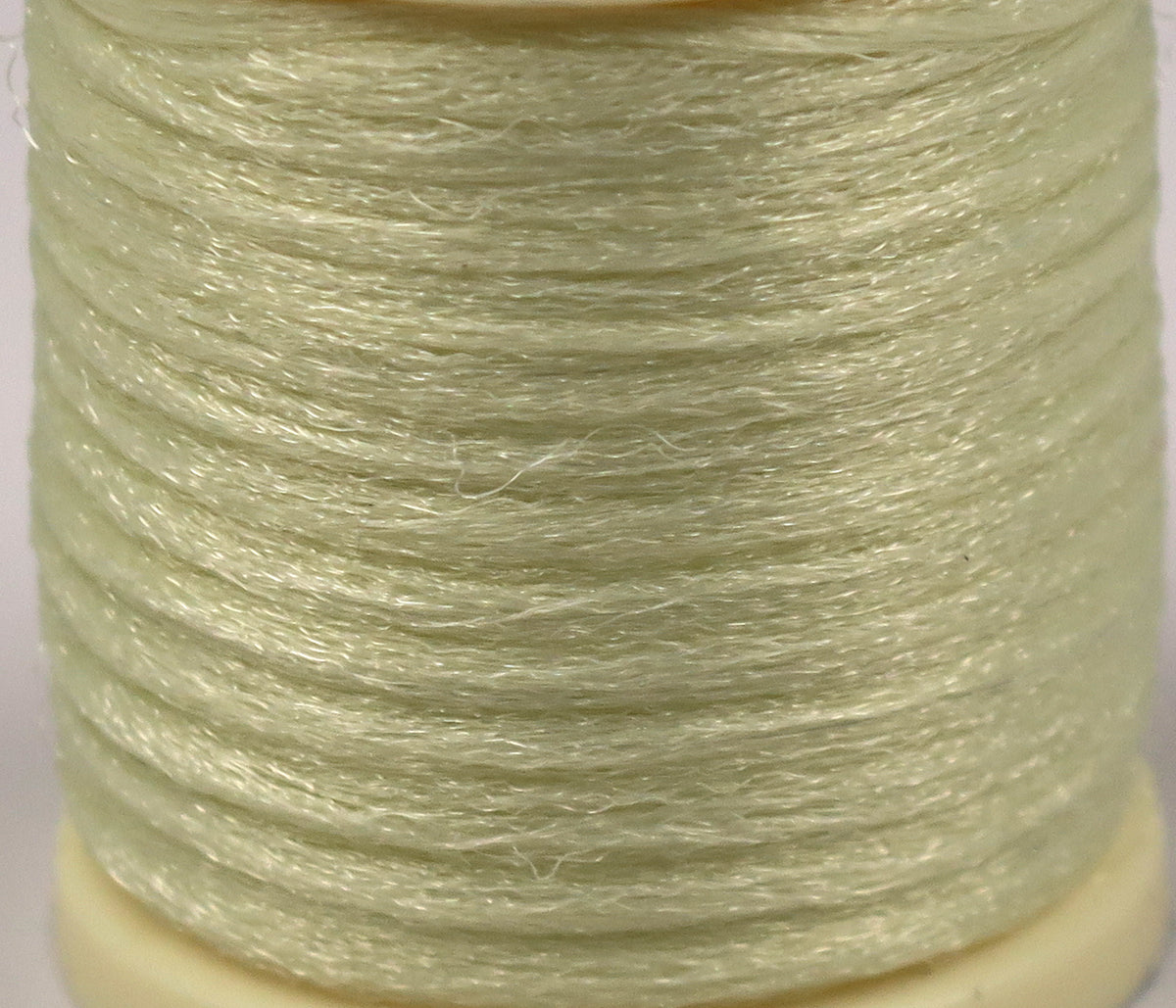 Hareline Antron yarn spool in pale chartreuse green with shiny synthetic fibers wound for fly tying
