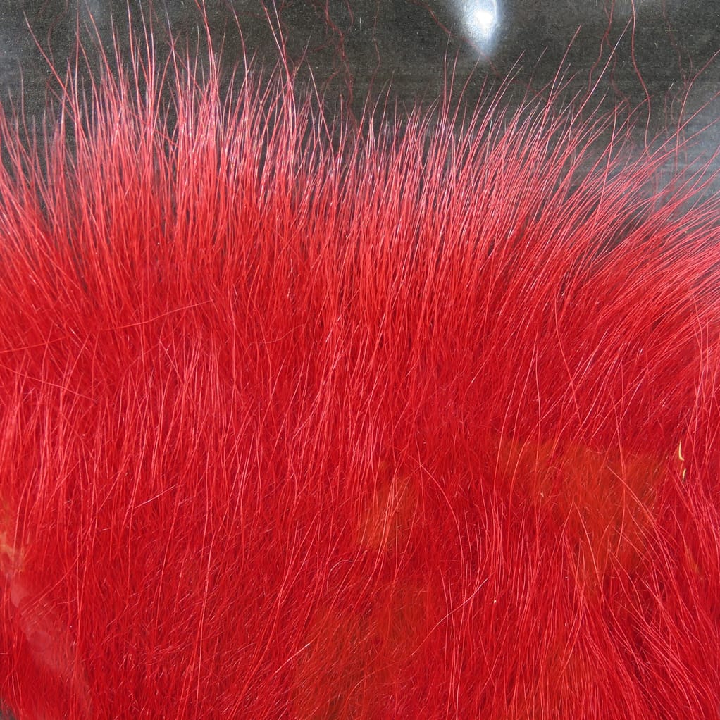 Dyed bright red Arctic fox tail hair with long glossy guard hairs and dense underfur for fly tying