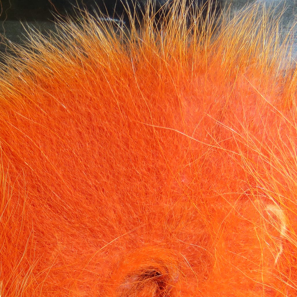 Hareline Arctic fox tail hair in bright orange — long soft fur with dense undercoat and longer guard hairs for fly tying