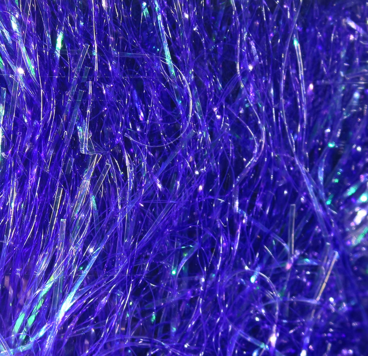 Purple iridescent Hareline Baitfish Emulator Flash synthetic tinsel strands with fine shimmering fibers for fly tying