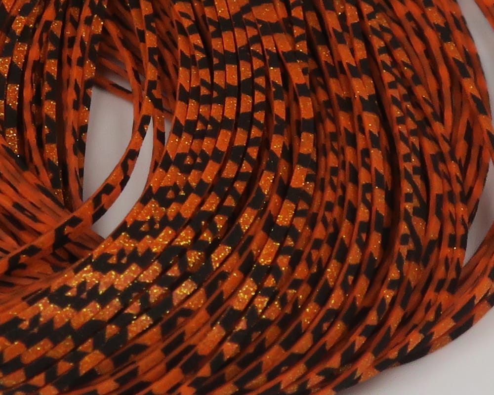 Hareline Barred Crazy Legs fly tying material - coiled orange and black barred synthetic legs with gold glitter