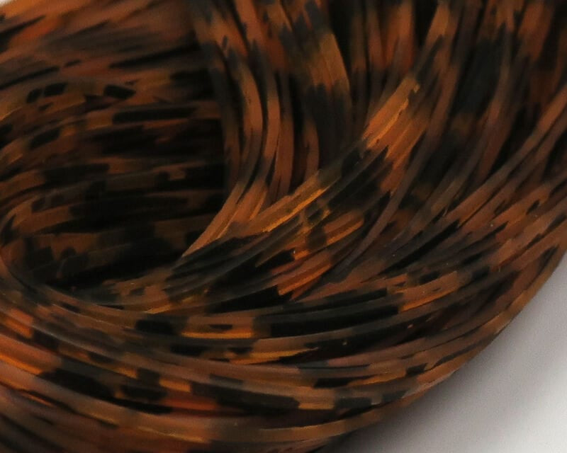 Hareline barred and speckled Crazy Legs orange-brown and black mottled rubber strands for fly tying