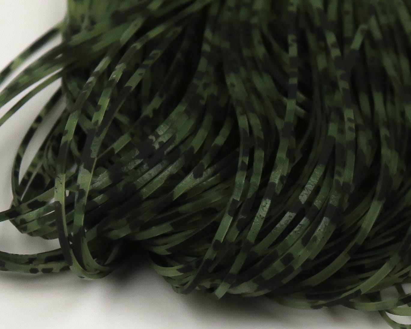Olive green Hareline Crazy Legs: thin flat synthetic rubber strips with black barred and speckled pattern for fly tying