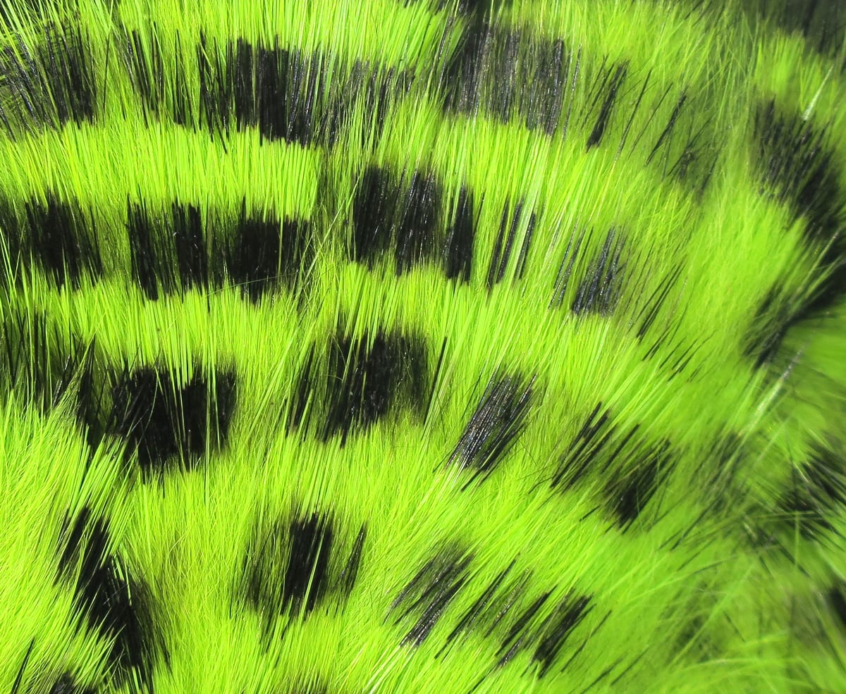 Bright chartreuse rabbit fur strips with bold black barred spots, long soft fur for fly tying and streamers