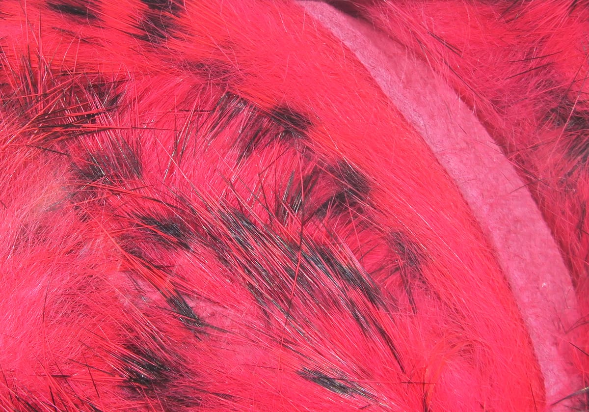 Dyed hot pink rabbit fur strips with black-barred pattern for fly tying