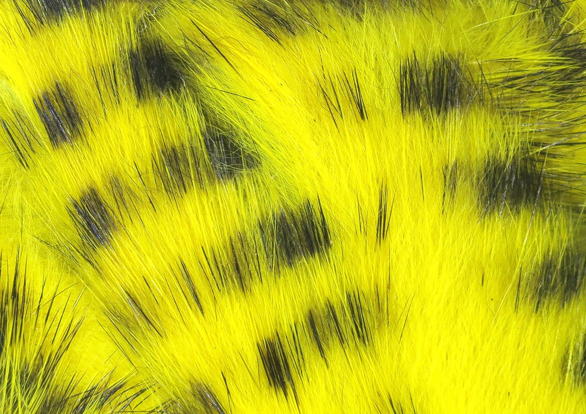 Bright yellow Hareline black-barred rabbit fur strips with distinct black bars for fly tying