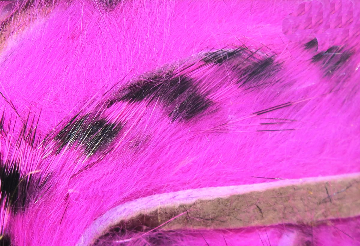 Bright pink dyed rabbit fur strips with black barred markings on backing, soft fur for fly tying and crafting