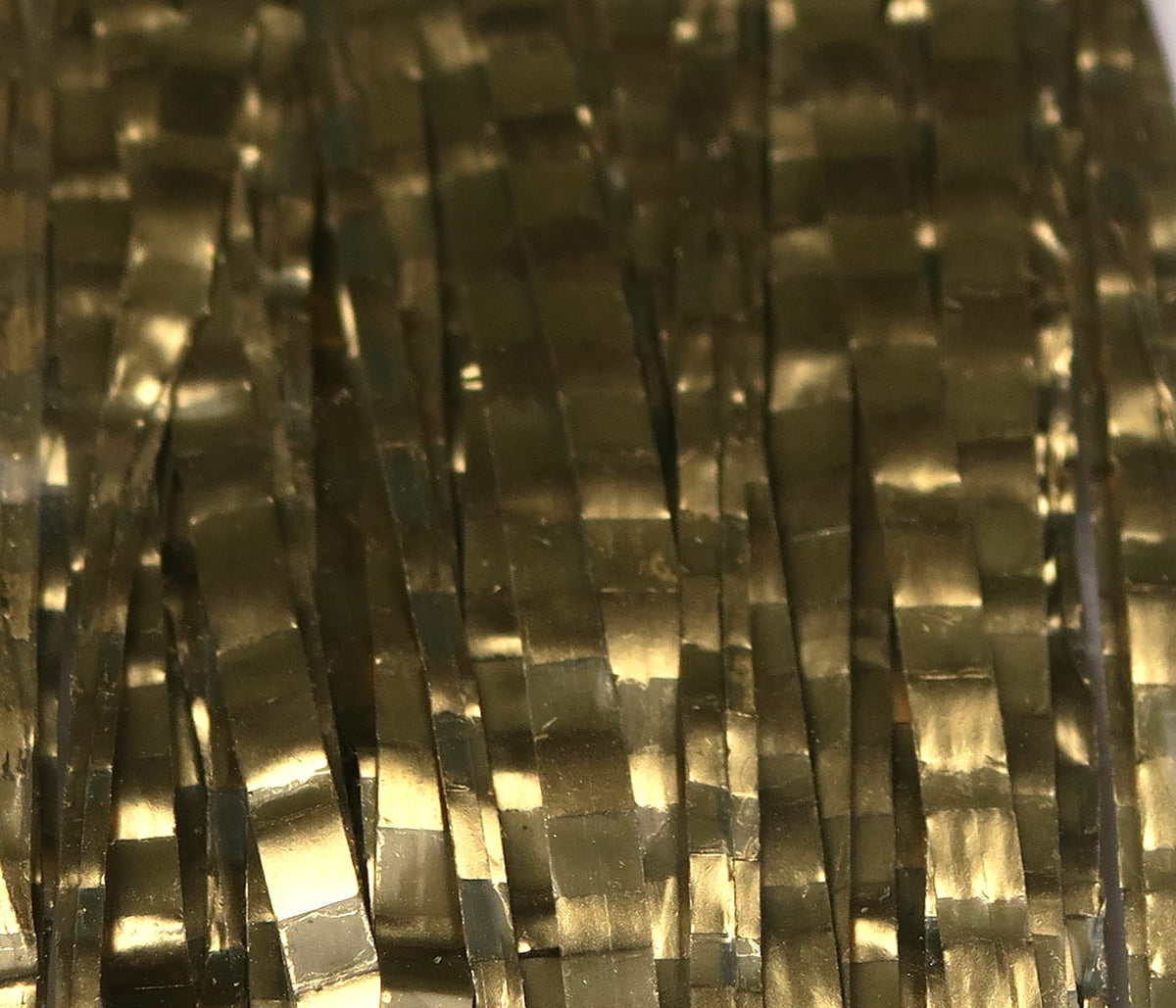 Hareline Barred Matrix fly fiber, close-up of olive-gold metallic synthetic strips with barred reflective pattern for fly