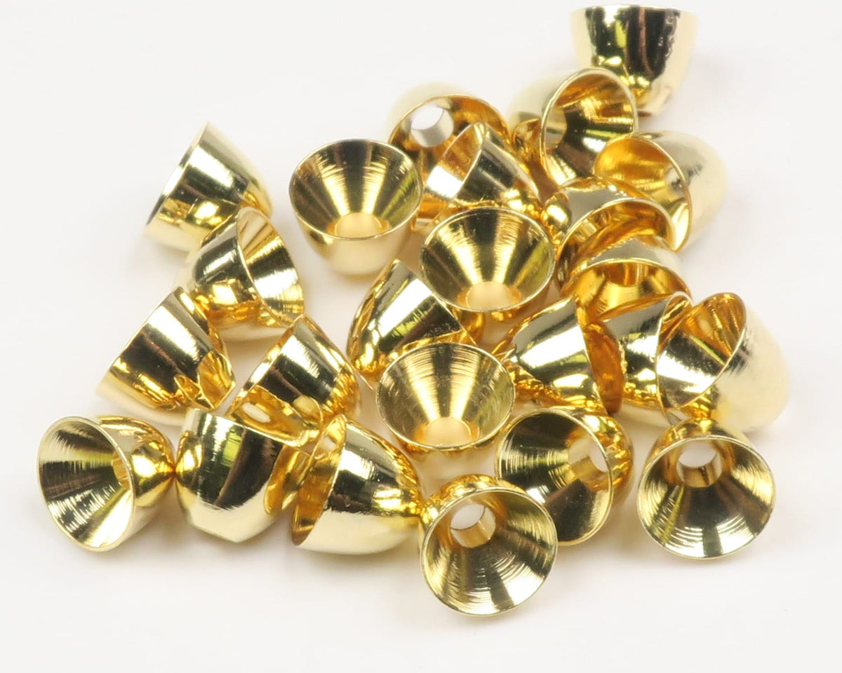 Shiny gold brass cone heads for fly tying, small polished conical beads with center holes scattered on white background